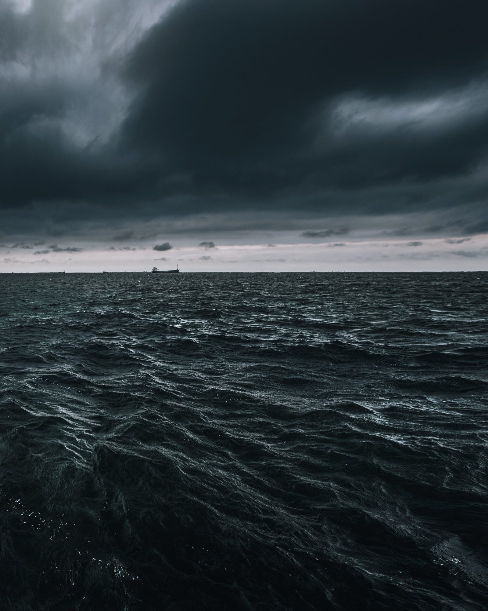 Bulk carriers at anchor on a dark sea